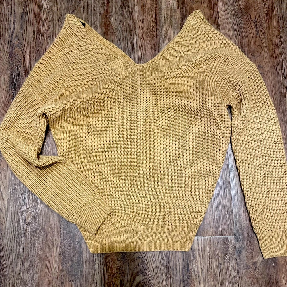 Off the shoulder, knotted back, cable knit sweater.